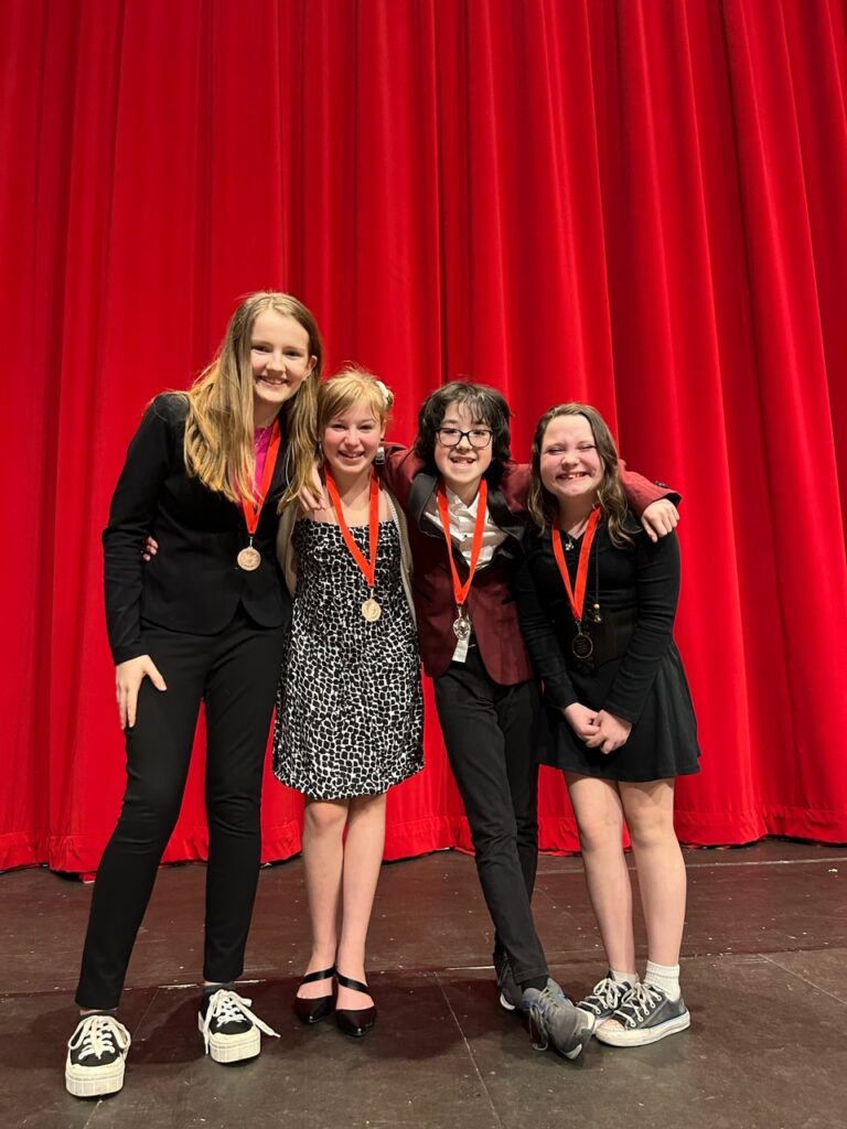 left to right storytelling: Gwen Black 4th, Cordelia Schultz 3rd, Scout Groshong 2nd, Maddie Rude 1st
